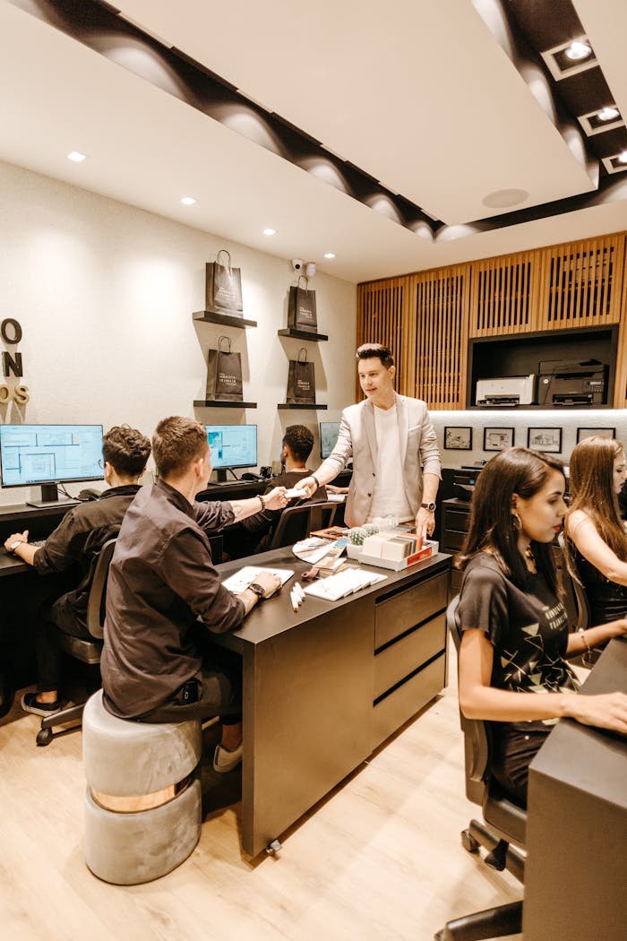 Colleagues collaborating in a contemporary office setting, engaging in creative discussions.