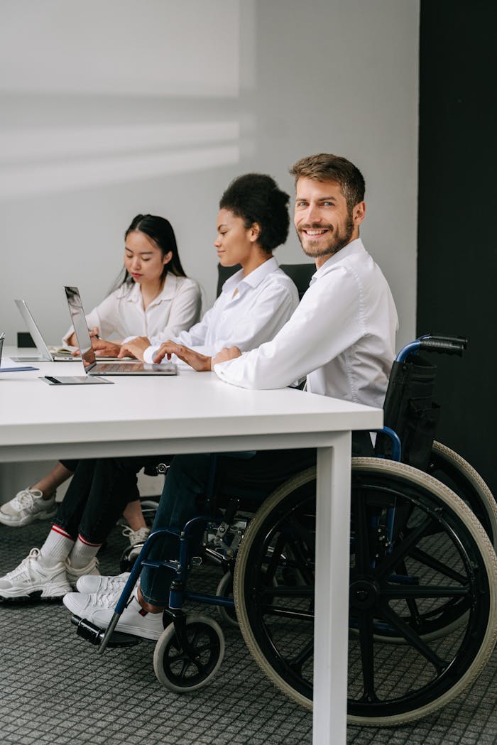 A diverse team of professionals working together at a modern office table, promoting inclusion.